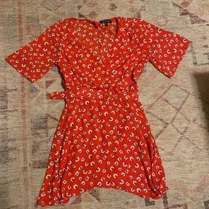 Francesca’s red belted wrap dress